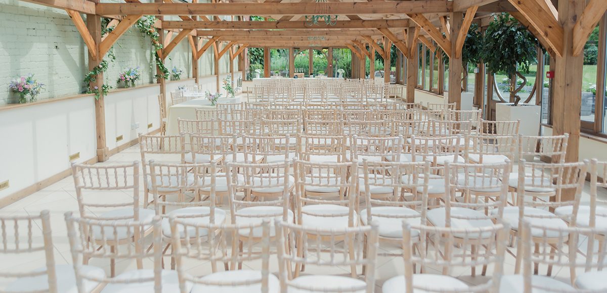 The Orangery at Gaynes Park wedding venue in Essex is set up for a beautiful spring wedding
