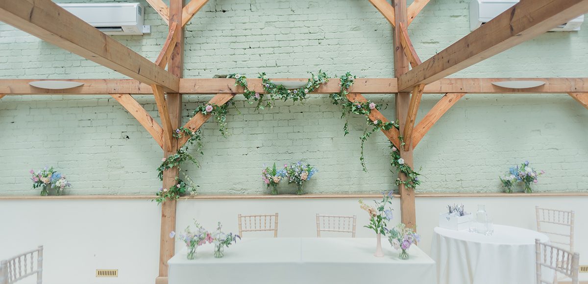 The Orangery at the Essex wedding venue is decorated with spring wedding flowers