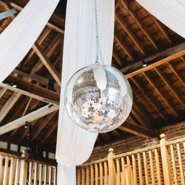 For the wedding reception a glitter ball hung from the ceiling in the Mill Barn at Gaynes Park