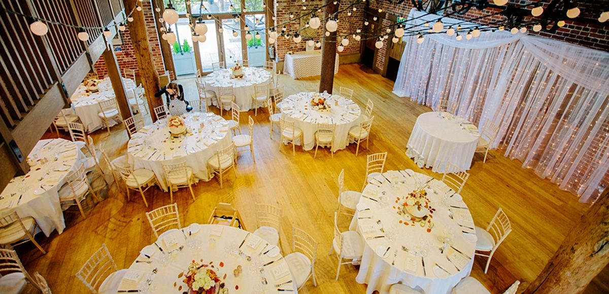 The Mill Barn at this Essex wedding venue is set up for a beautiful autumn wedding reception