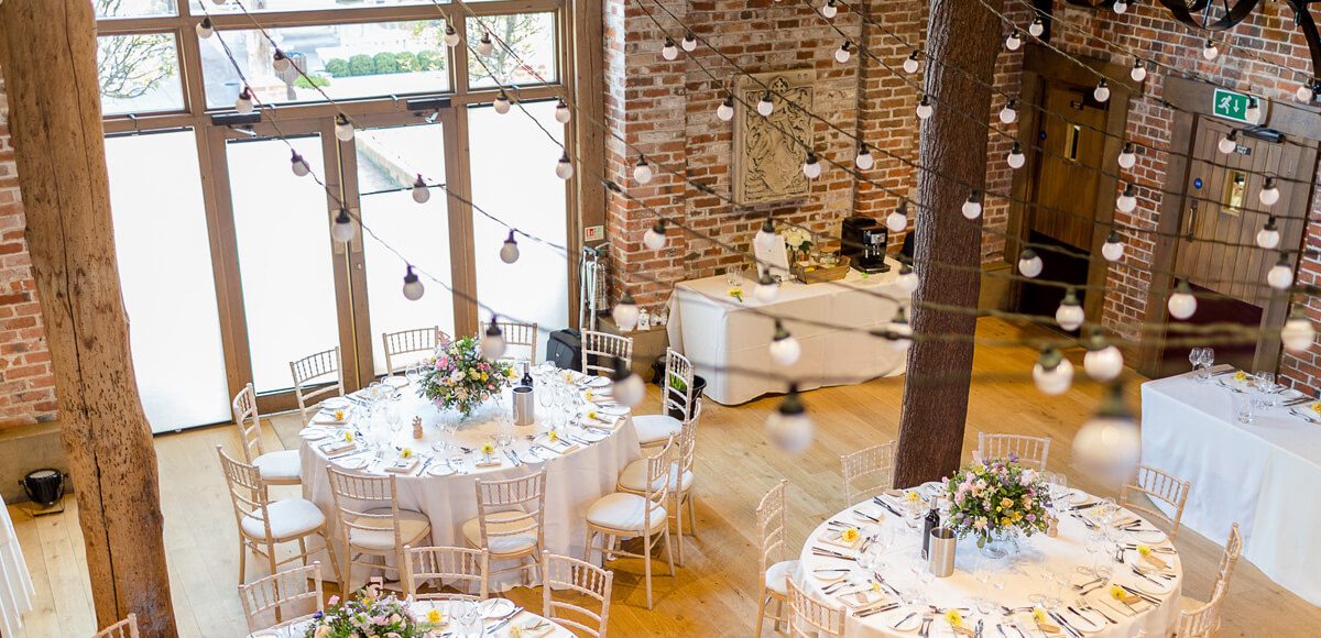 The newlyweds hung festoon lights within the Mill Barn for a rustic wedding look