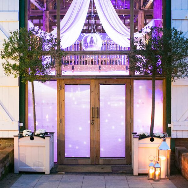 Outdoor lanterns add a warm welcome to evening guests entering the Mill Barn at Gaynes Park