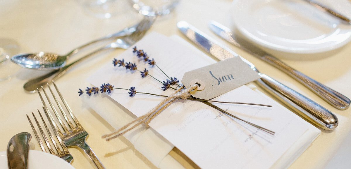 Rustic wedding stationery was used to decorate tables in the Mill Barn at Gaynes Park