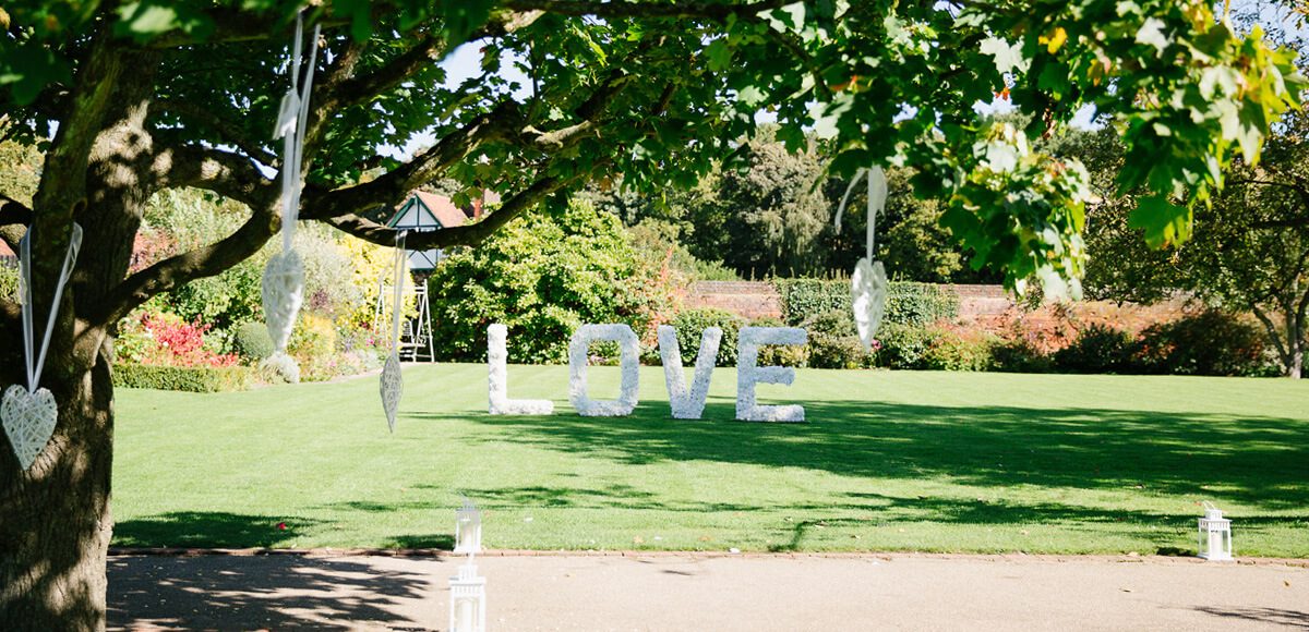 Large love letters are placed on the lawns in the Walled Gardens at Gaynes Park for a fantastic
