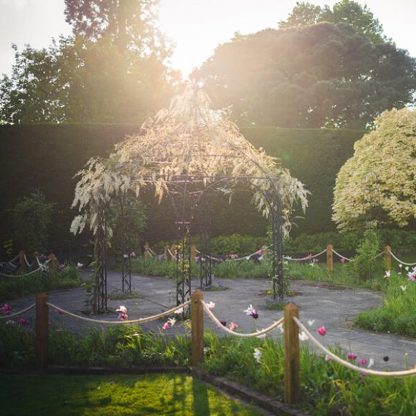 The sun shines down on the beautiful Pavillion that sits in the Walled Gardens at Gaynes Park wedding venue in Essex