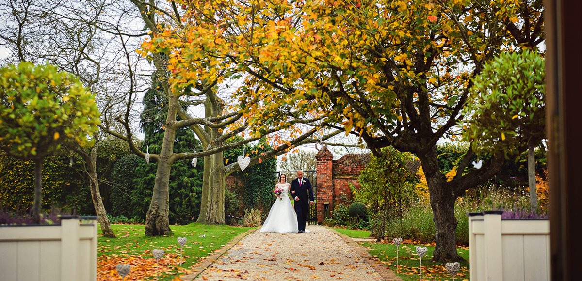 The wedding aisle in Gaynes Park’s Walled Garden looks beautiful for an autumnal wedding