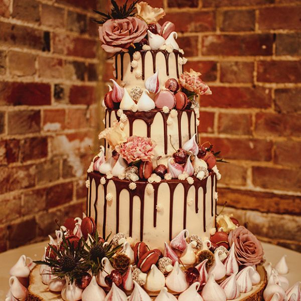 The wedding cake for this Gaynes Park wedding was decorated with meringues and macrons