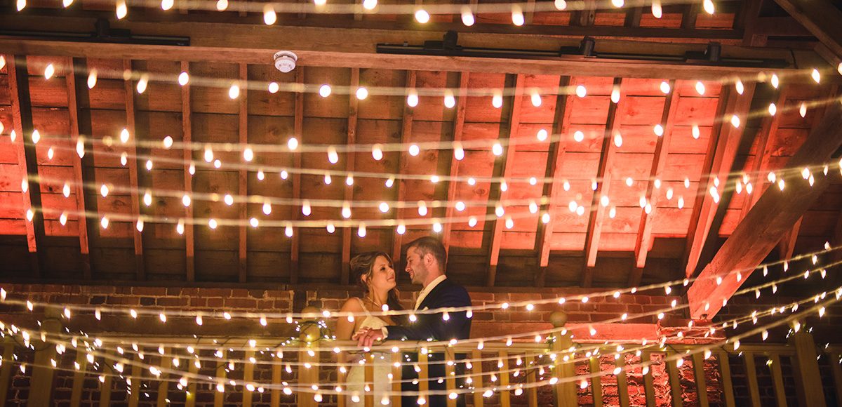 Fairylights are added to the Mill Barn at Gaynes Park for added sparkle at a rustic wedding