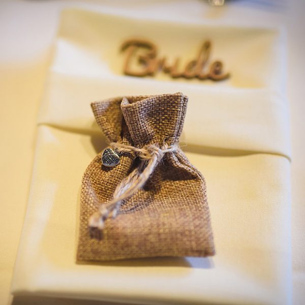 At Gaynes Park a couple put their wedding favours in a hessian bag for their rustic wedding