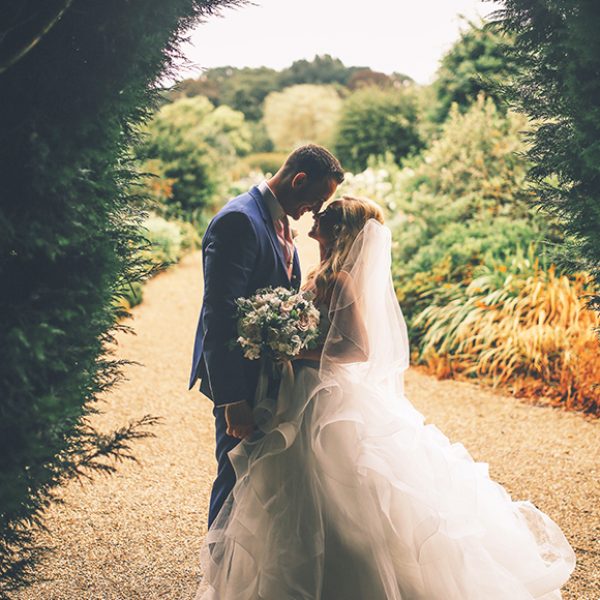 The newlyweds explore the stunning gardens at Gaynes Park wedding venue in Essex