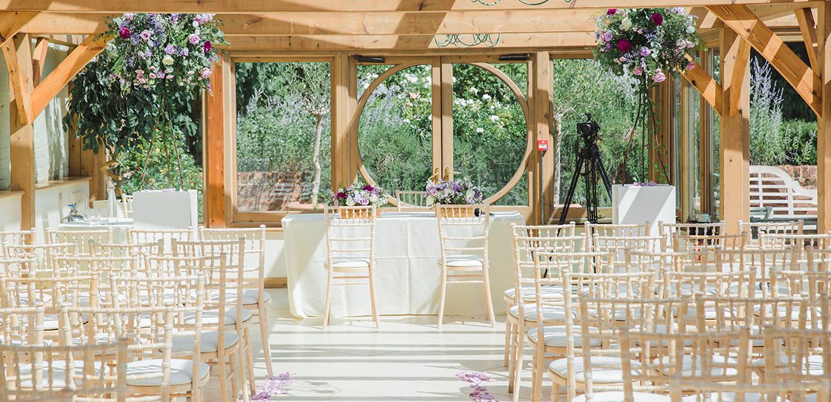 The Orangery at Gaynes Park is set up for a summer wedding ceremony