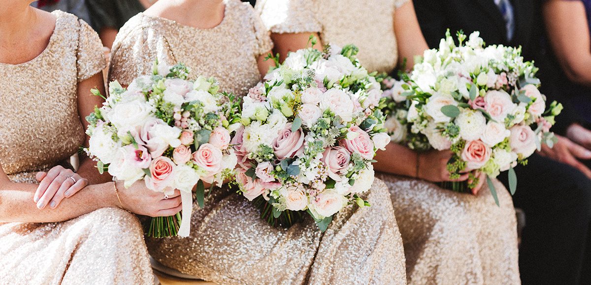 Bridesmaid bouquets are made up of pink roses for a beautiful spring wedding at Gaynes Park