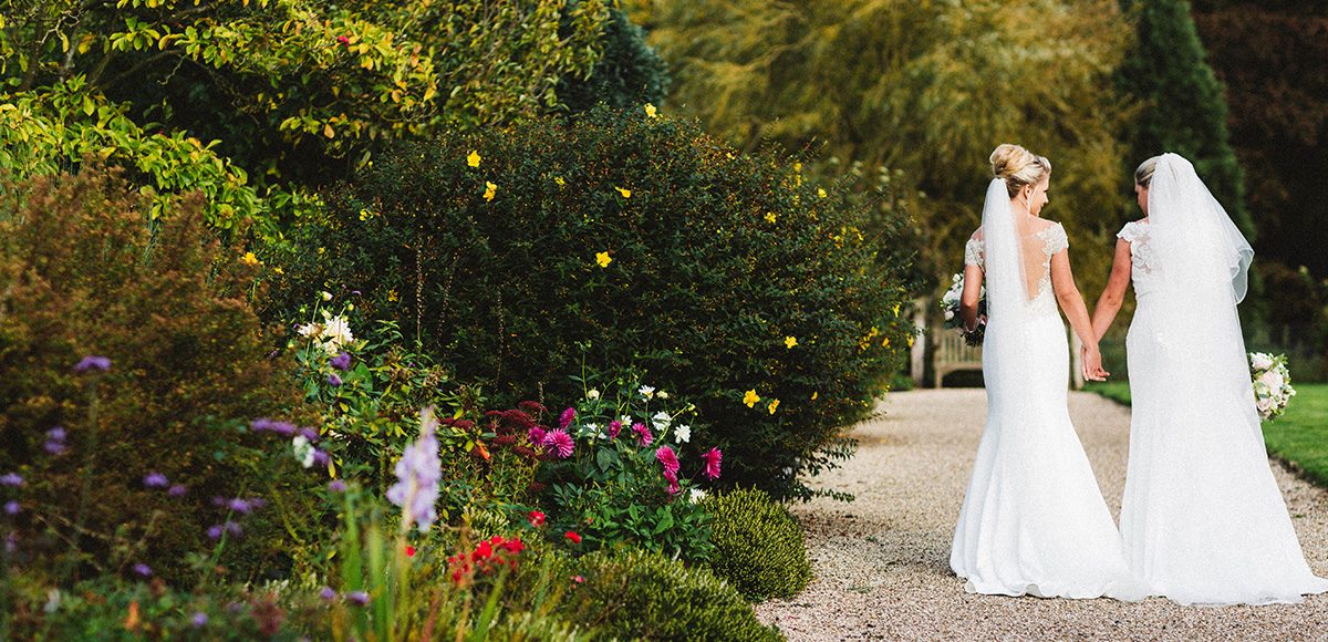 White wedding dresses really stand out against the colour in the gardens at Gaynes Park in Essex