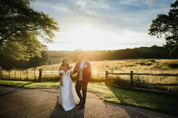 Couple walking along the Entarnce Drive at Gaynes Park in golden hour