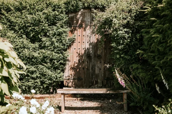 Wooden bench on the Long Walk at Gaynes Park wedding venue